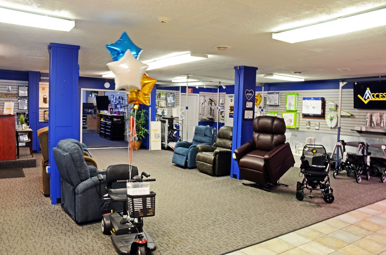 Wide-angle shot of the Access Elevator, Inc. Cudahy showroom featuring home elevators, stair lifts, and mobility equipment on display.