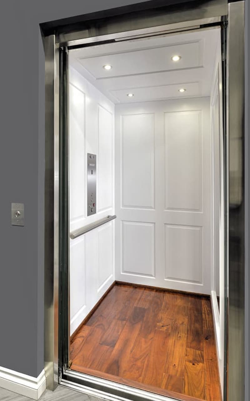 Modern home elevator with glass doors and polished interior installed inside a residential home by Access Elevator, Inc.