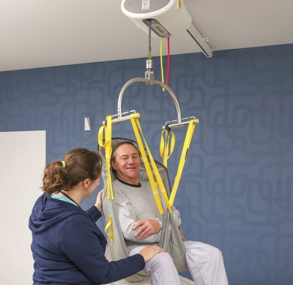 Ceiling lift track system installed along the ceiling of a bedroom and leading into an accessible bathroom by Access Elevator, Inc.