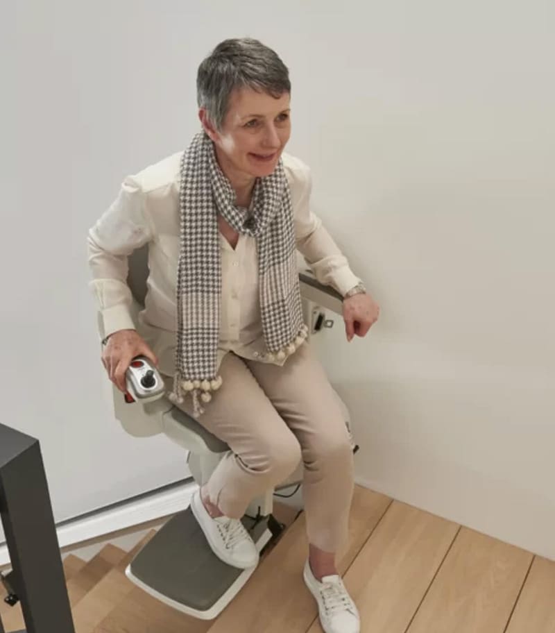 Access-BDD-HomeGlide-Exta-01 Access BDD HomeGlide Extra Straight Stair Lift Swiveled Out at Top of Stairs With User Making Safe and Easy Transfer