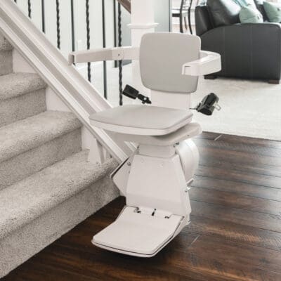 Bruno Elan Straight Indoor Stair Lift in Riding Position at Bottom of Stairs
