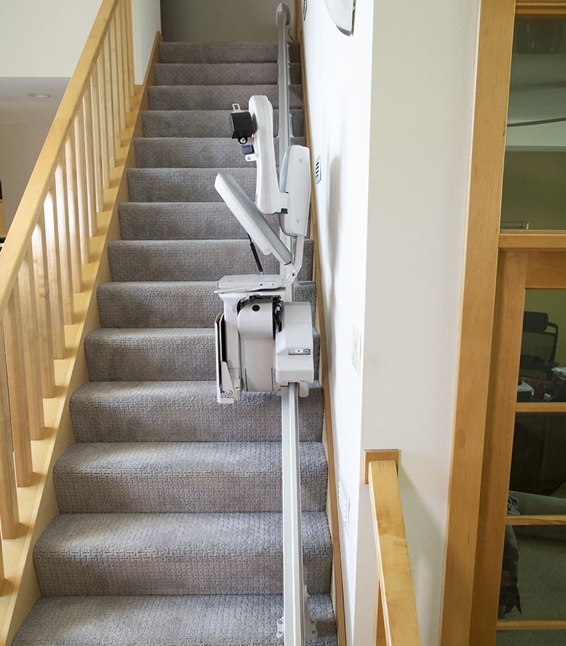 Bruno Elite High Weight Capacity Straight Stair Lift Halfway Up Carpeted Home Staircase in Folded Position