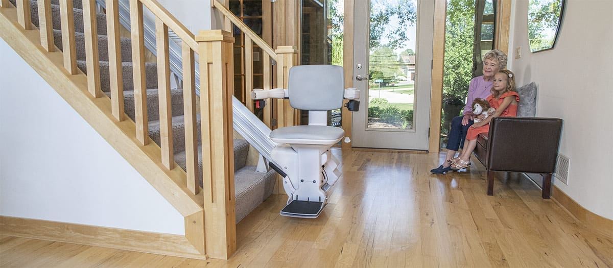 Bruno Elite Straight Bariatric Indoor Stairlift in Home with Wood Floor and Rails