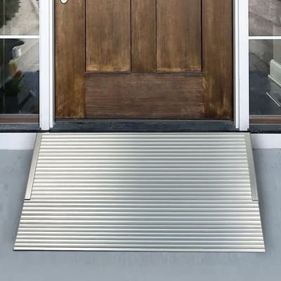 Aluminum Threshold Ramp from National Ramps sitting in front of door to allow easy wheelchair access