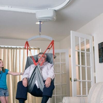 Bariatric elderly man using a fixed bariatric ceiling lift from SureHands for safe and comfortable transfer