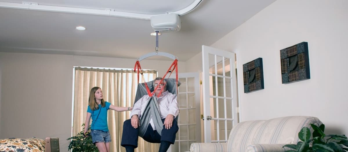 Bariatric elderly man using a fixed bariatric ceiling lift from SureHands for safe and comfortable transfer
