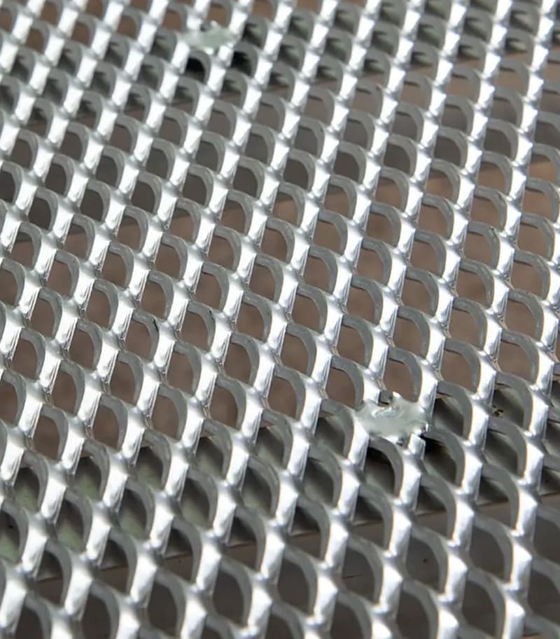 Close-up of aluminum mesh decking and structural support beams on residential wheelchair ramp manufactured by National Ramps
